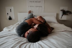 Young couple cuddling on a bed